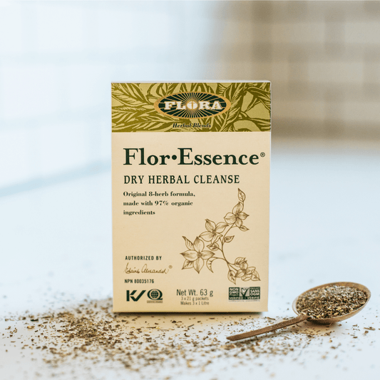 Flora Flor Essence Dry Herbal Cleanse in a 63 grams package on a table right next to a spoon with the product on it  Edit alt text